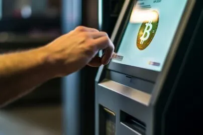 Bitcoin ATM With A User Completing A Transaction