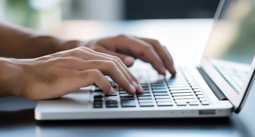 Person's Hand Typing On A Sleek, Modern Keyboard